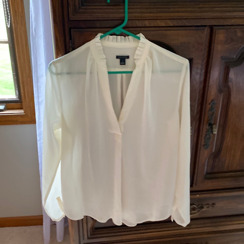 Cream blouse with ruffle around neck